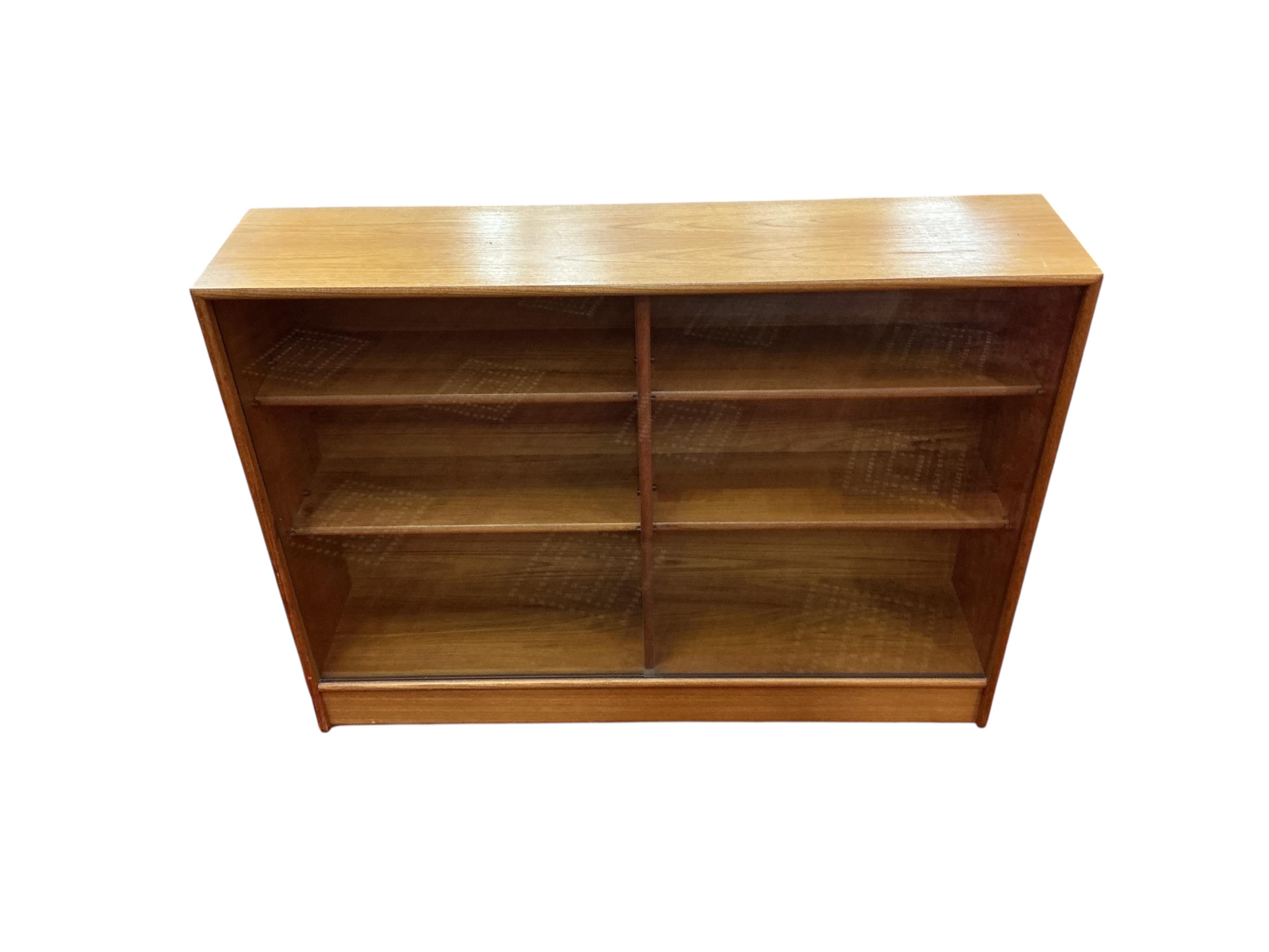 A mid century glazed teak bookcase, width 122cm, depth 28cm, height 90cm